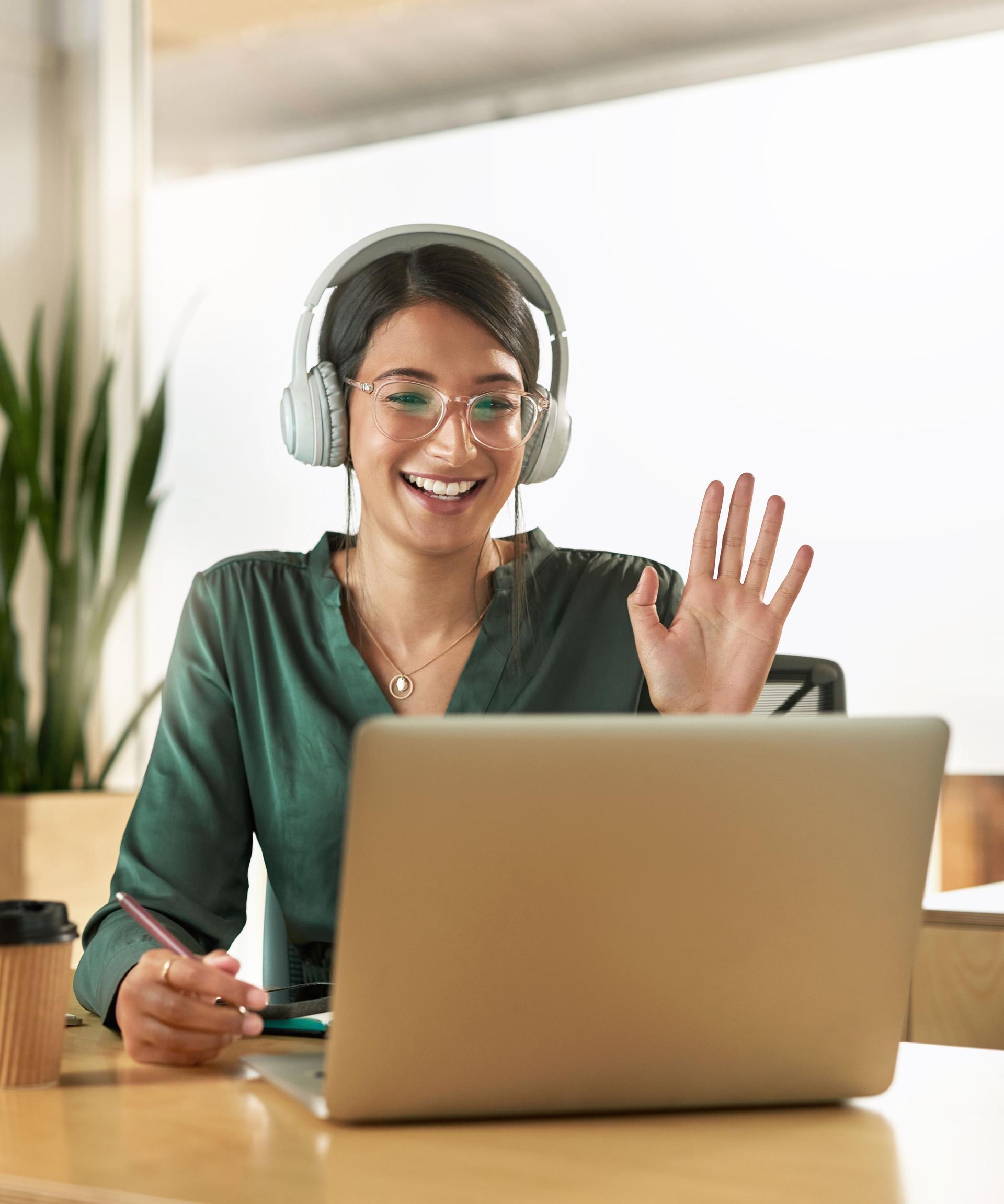 Shot of a young businesswoman using her laptop to host a video conference at work